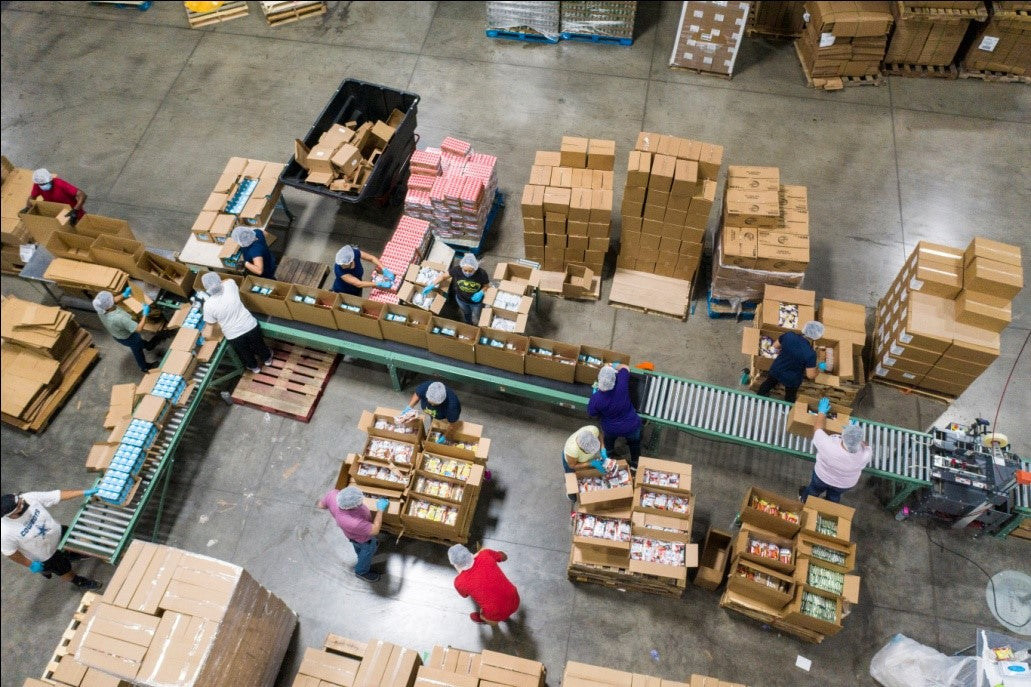 Inaithiram Material Handling Warehouse in Operation Workers moving packing and moving materials in carton boxes